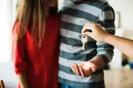 House keys being handed to a couple